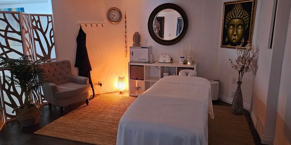 Cozy massage room with warm lighting and calming decor.