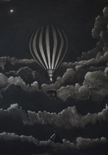 Hot air balloon flying at night through clouds.