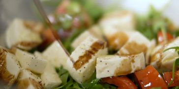 Salad with grilled cheese and balsamic dressing.