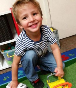 Young boy playing with trucks