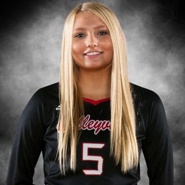 Female volleyball player in black jersey with number 5.