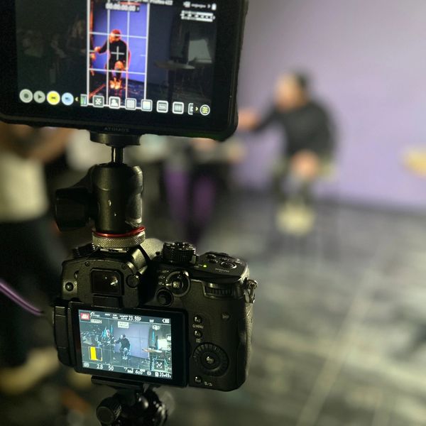 Our director setting up the shot on the hot seat of our film stage, viewed from camera angle