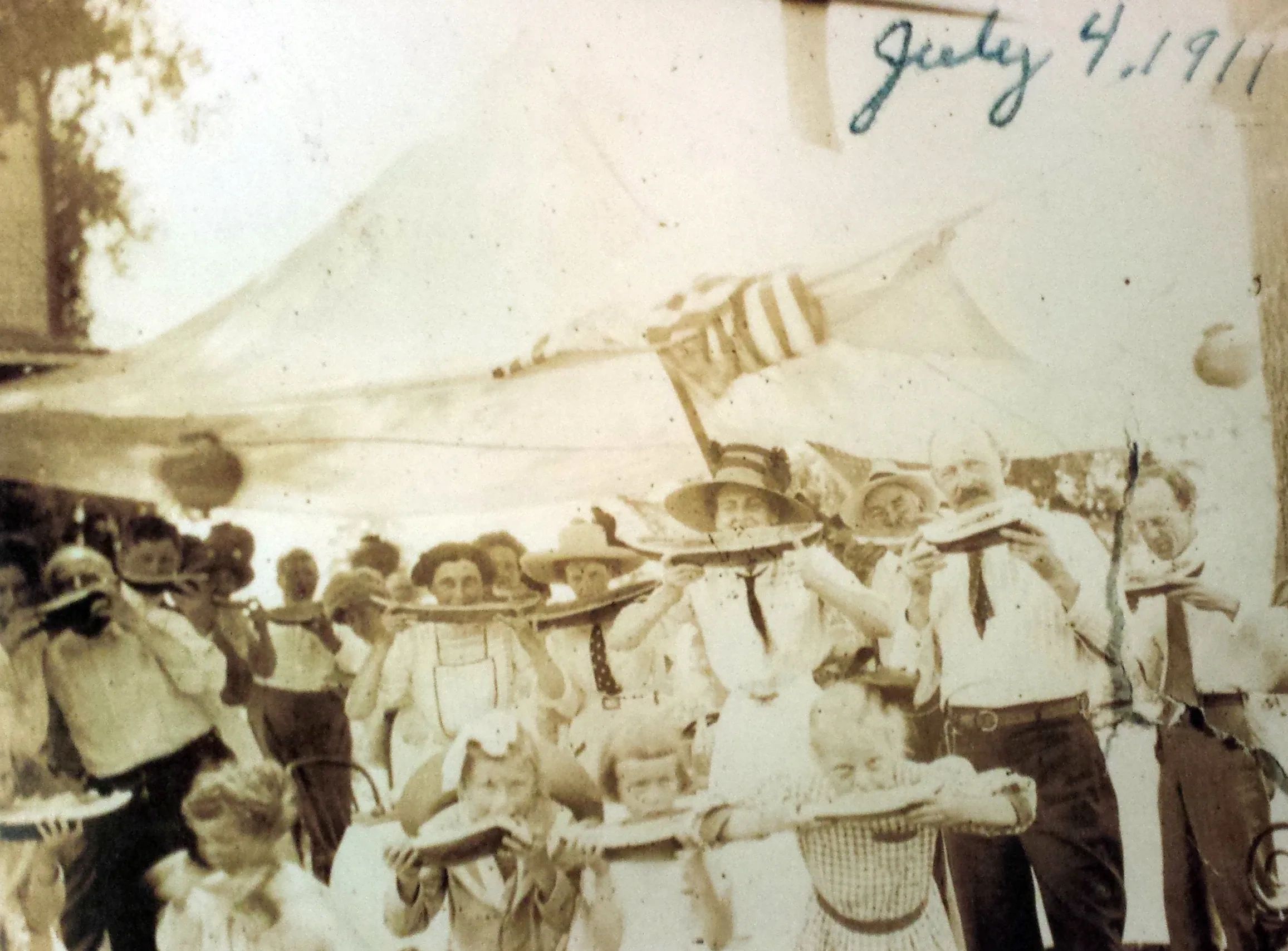 Fourth of July 1911, a patriotic group of "Free Staters" take a simultaneous chomp of Watermelon. 