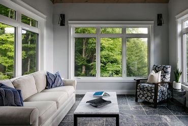 A beautiful vaulted ceiling sunroom overlooks the forest of Haliburton and Redstone Lake. 