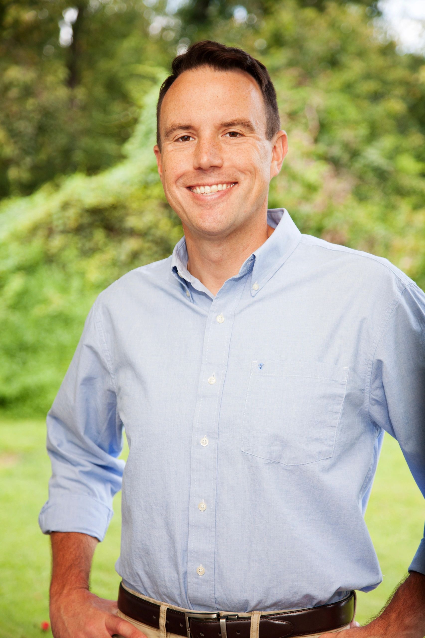 Bryan Allen smiling in a light blue button up