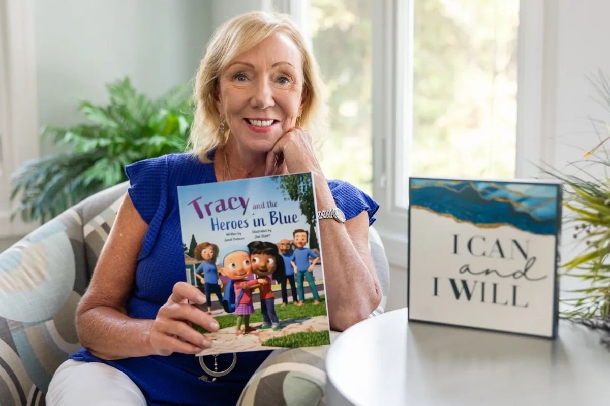 A person sitting on a couch and holding books