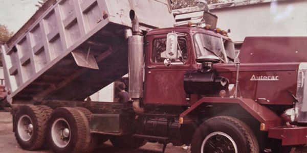 Old dump truck with raised bed.