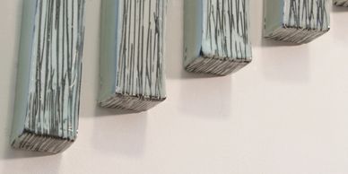 Detail image of porcelain wall sculpture, four ascending pieces, celadon blue with black lines