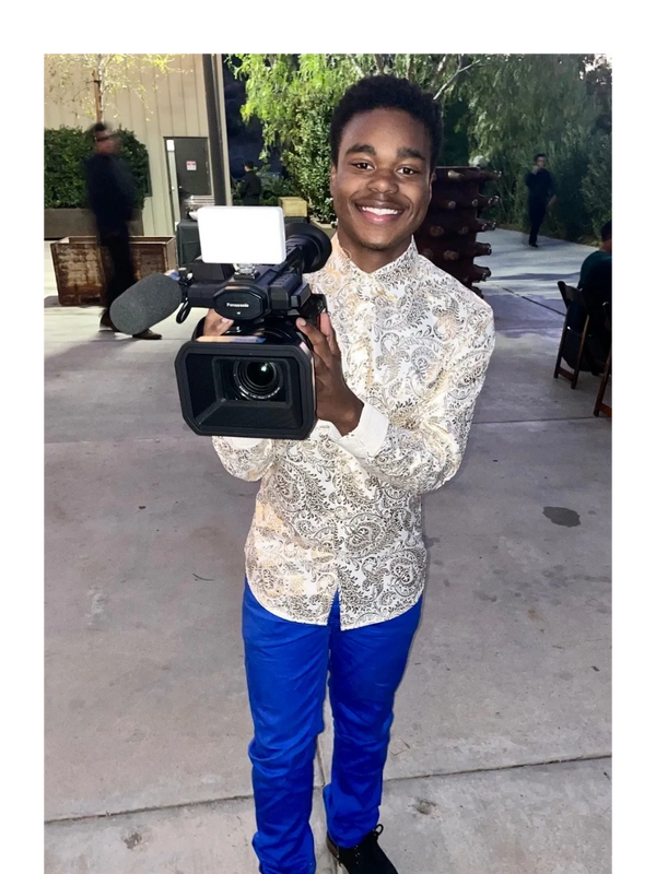 Actor and activist Lance Alexander holding a camera.