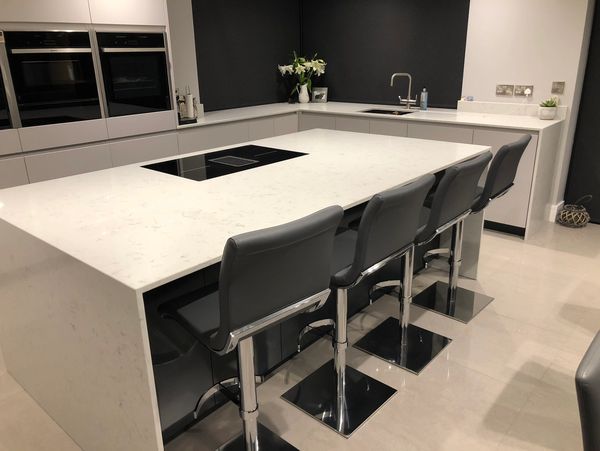 Interior Kitchen with Island, Sink, Cabinets, and Hardwood Floors in New Lux Home