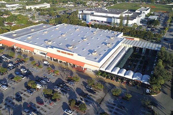 Aerial view of a Home Depot store featuring a large parking lot filled with cars