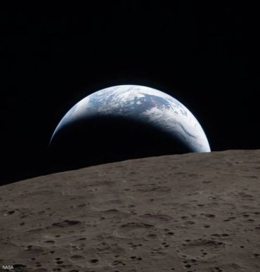 Earth rising over the lunar horizon captured from the Moon.