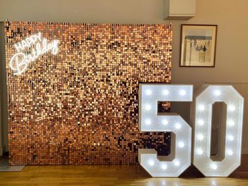 rose gold sequin wall with neon happy birthday and 4 foot illuminated numbers