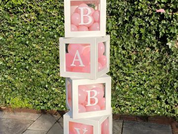 large perspex baby boxes, White wood frame. Can be filled with balloons. For hire in sussex