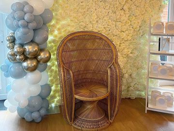 Large peacock chair and flower wall, wedding display