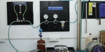 Laboratory setup with gas soundness testing equipment and gauges.