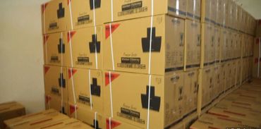 Stacked cardboard boxes lined up in a storage area.