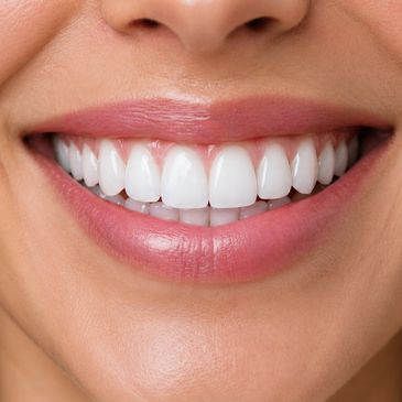 Close-up of a bright, healthy smile with white teeth and pink lips.