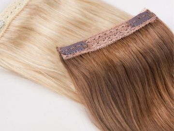 Two hair extensions, one blonde and one light brown, laid flat.