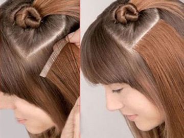 Woman styling hair with a comb to create a heart-shaped parting.