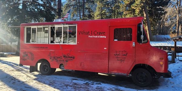 A picture of the iconic red What I Crave Food Truck, showing the history of our brand.