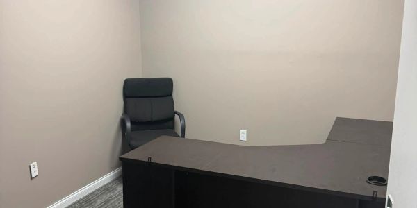 Empty office space with a desk and chair.