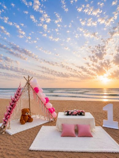 Beach setup for a first birthday celebration at sunset.