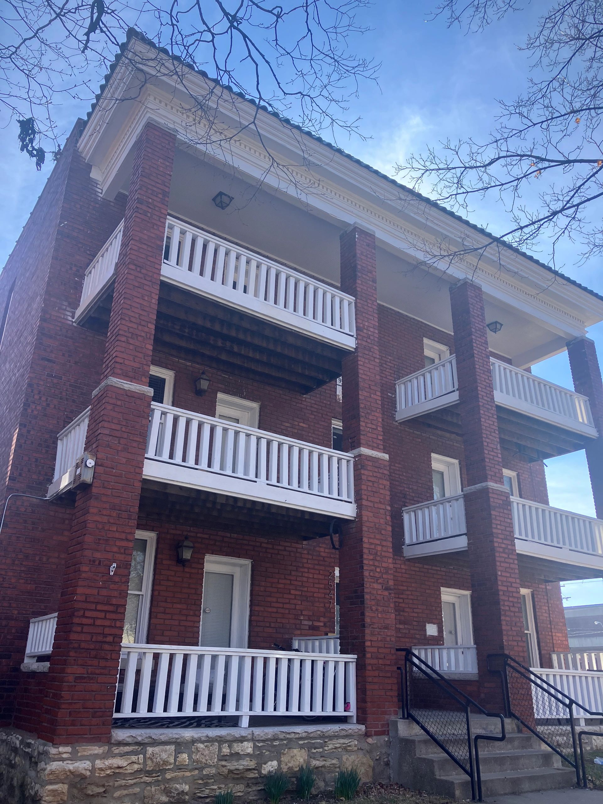Brick apartment building with white balconies at 2547 Cherry St, Kansas City