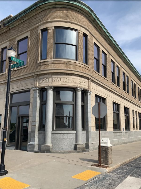 Historic First National Bank building on corner of Maple and M Adams St.