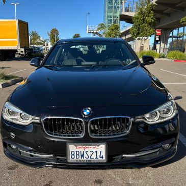 Front view of a black BMW car with California license plate.
