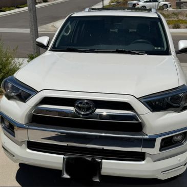 Front view of a white Toyota SUV parked outdoors.