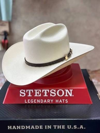 White Stetson cowboy hat displayed on a red stand with 'Legendary Hats' text.