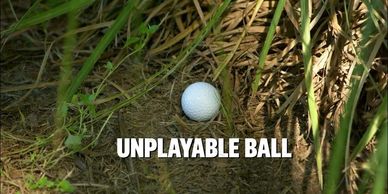 A golf ball in thick grass labeled 'Unplayable Ball'.