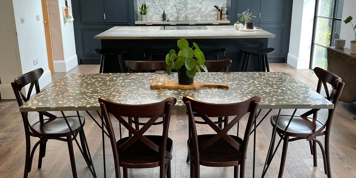 Terrazzo and metal dining table seating 6 displayed in a modern kitchen