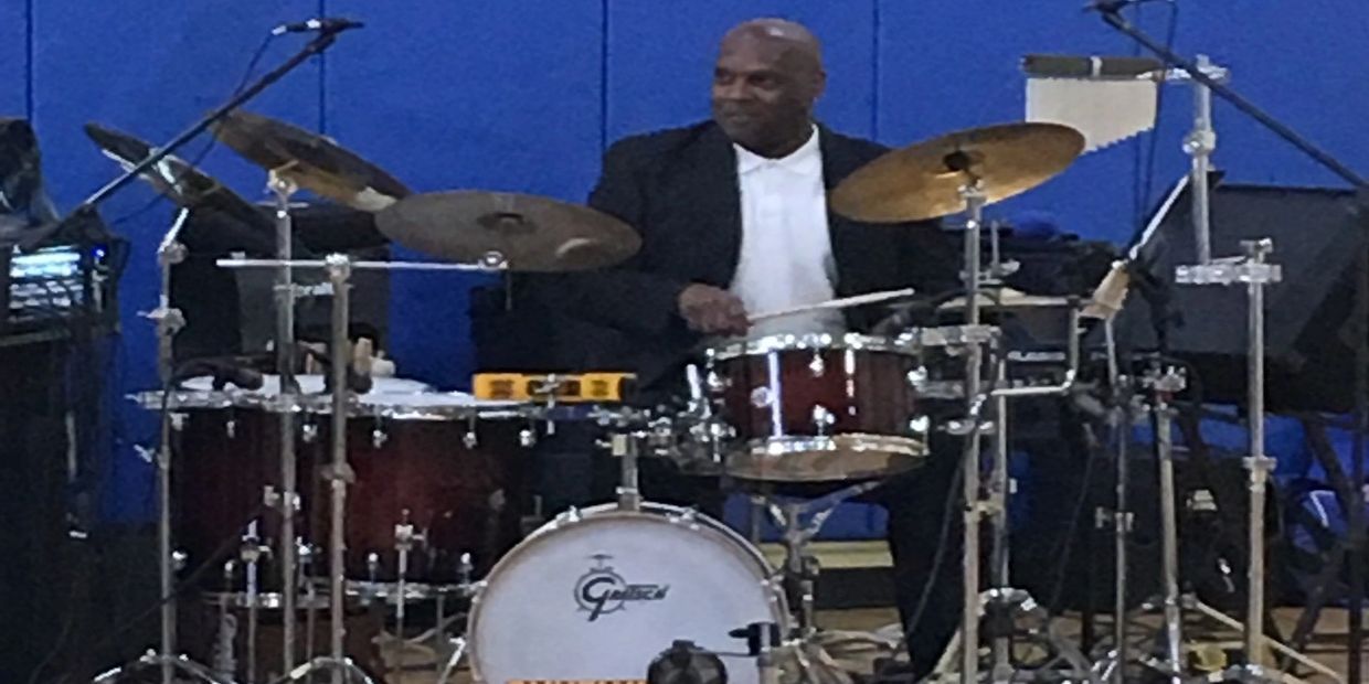 Man playing drums in a music setup.