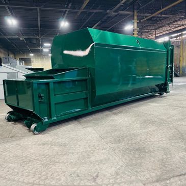 Green self-contained compactor built by Elite Containers