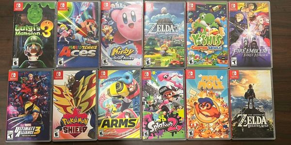 Collection of 12 popular Nintendo Switch game cases arranged on a table.