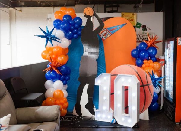 Basketball-themed party setup with balloons and number 10 sign.
