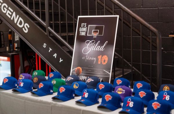 Basketball-themed birthday party hats and sign.