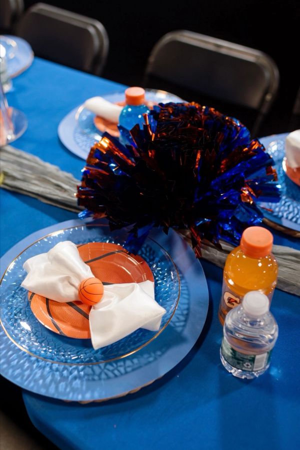 Basketball-themed table setting with pom-pom centerpiece.