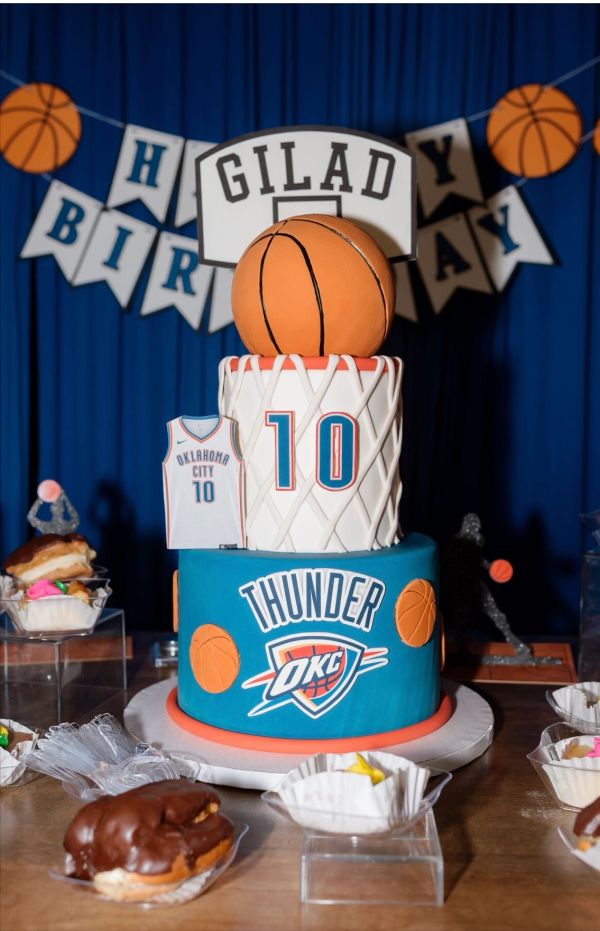 Basketball-themed birthday cake with Oklahoma City Thunder design.
