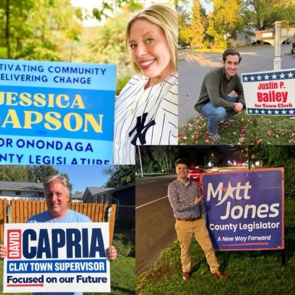 Four candidates posing with their political campaign signs.