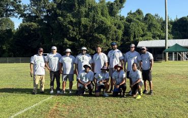 Group photo of a baseball team on a sunny field.
