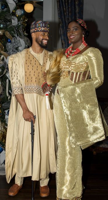 Couple in traditional Nigerian attire smiling and posing.