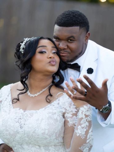 Happy newlyweds posing playfully.