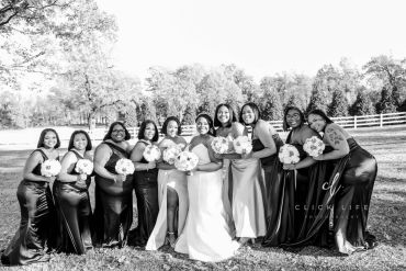 Bridesmaids and bride posing with bouquets outdoors.
