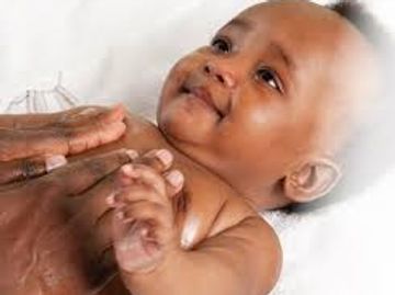 A baby receiving a Baby Massage