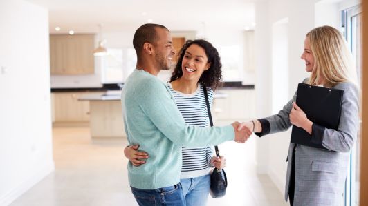 A team of experts in professional office removals carefully loads modern office furniture into a large removals lorry outside a glass commercial building. The branding of the commercial movers services is clearly visible on the vehicle, symbolising efficient and organised business relocation.
