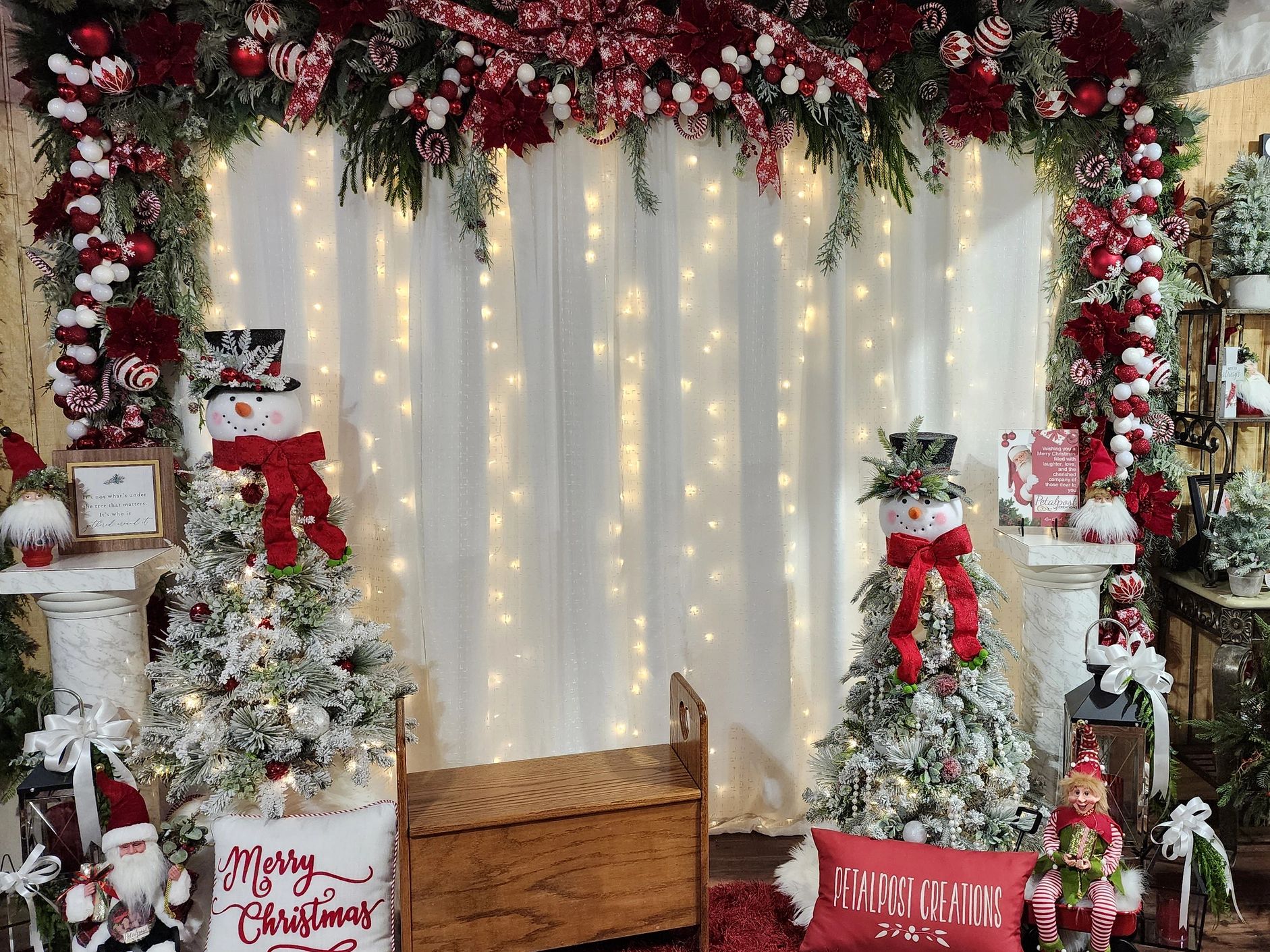 Festive Christmas setup with snowmen, garlands, and holiday decorations.