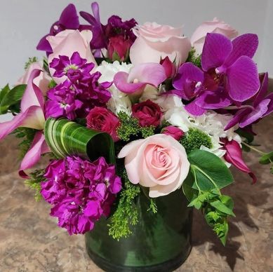 Pink Roses and purple orchid arrangement